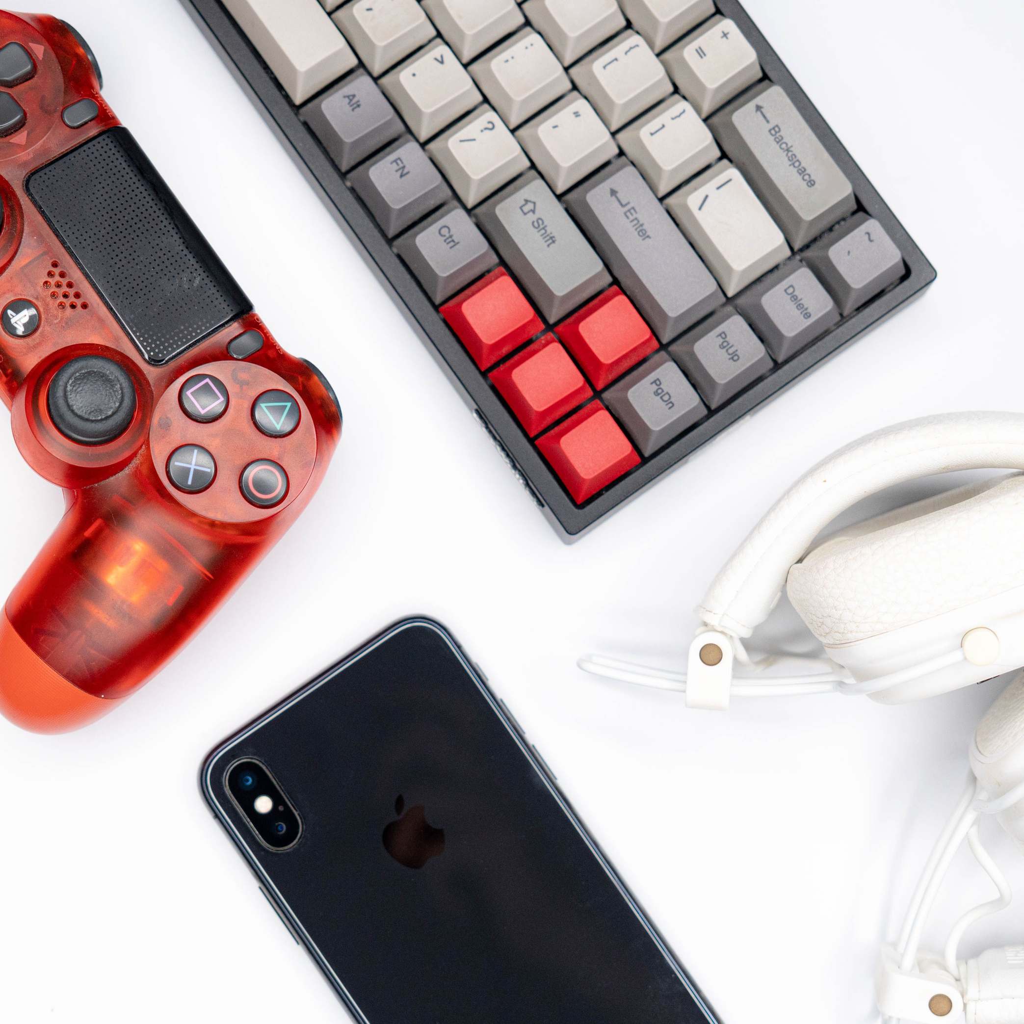 Overhead view of keyboard and gadgets on a white background